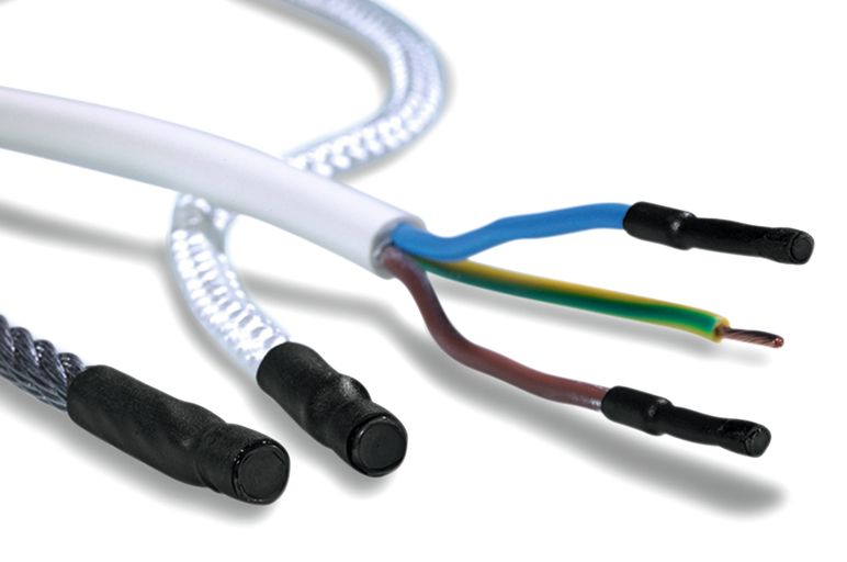 Pinched heat-shrinkable end caps for protection of stub splices